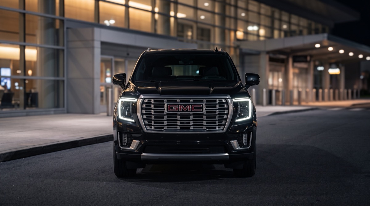 Luxivo's Yukon XL Denali at an airport terminal curbside at night