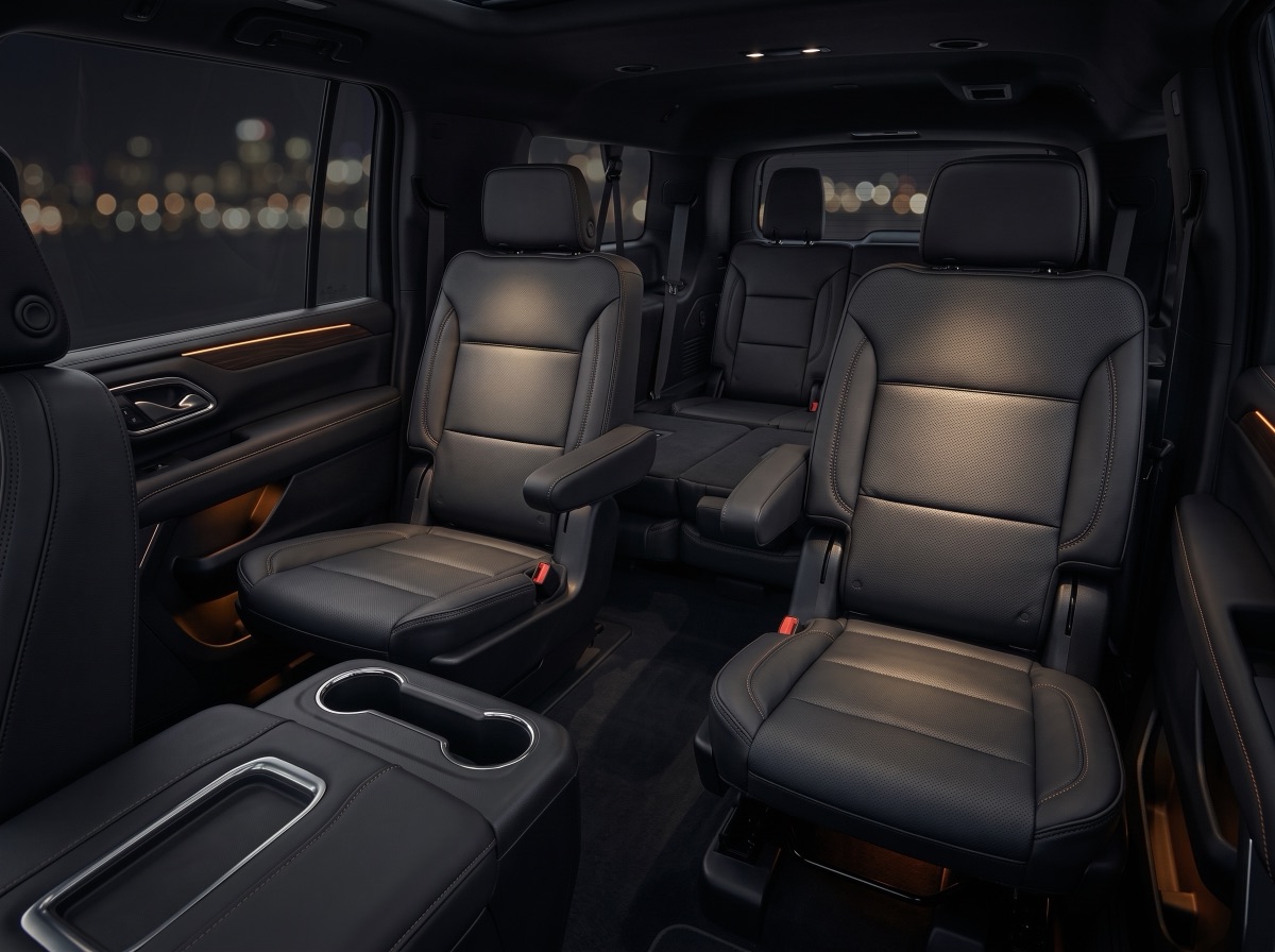 The cabin of Luxivo's Yukon XL Denali looking back across the quad captain's chairs to the third row